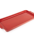 A red ceramic appetizer platter on a white background.