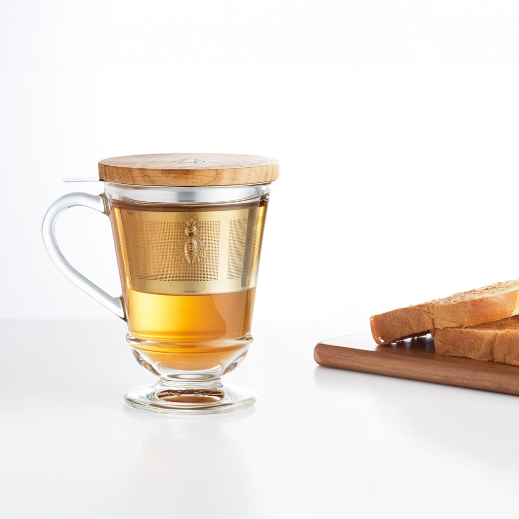 La Rochere Glass Bee Infuser Mug filled with tea.